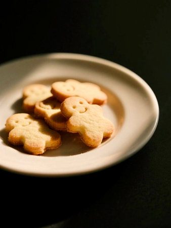 Cookies on a white plate on a black background. Selective focus.