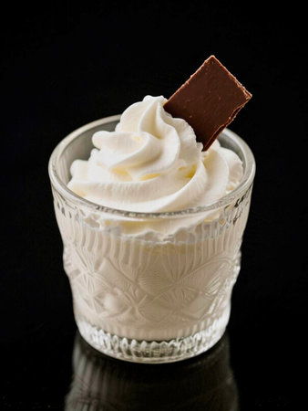 Vanilla ice cream in a glass with chocolate on a black backgroundの写真素材