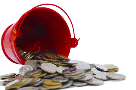 bucket spill out many coins over white backgroundsの写真素材