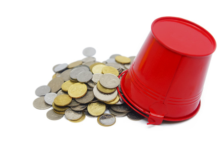 bucket spill out many coins over white backgroundsの写真素材