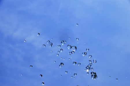 water splash over blue sky backgroundの写真素材