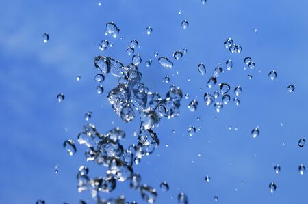 water splash over blue sky backgroundの写真素材