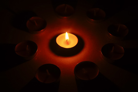 burning candle in the darkの写真素材