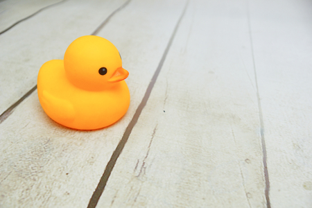 Yellow duck toys over wooden table topの写真素材