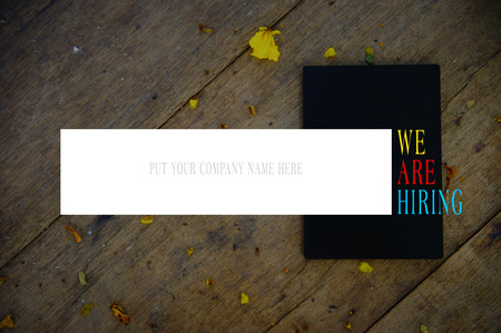 WE ARE HIRING Text And Blank White Box Over Underexposed Wooden Backgroundの写真素材
