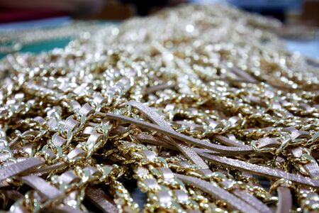 Gold necklace with Pink leather strap Backgroundの写真素材