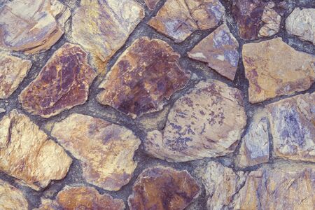 Natural backgrounds of colored stones with square shape on the wall, use for outdoors decoration.