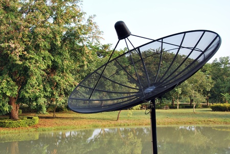 communication satellite dish over sunset skyの写真素材