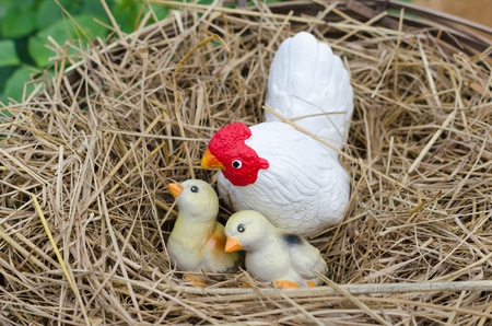 Statue of chickens on a pile of straw の写真素材