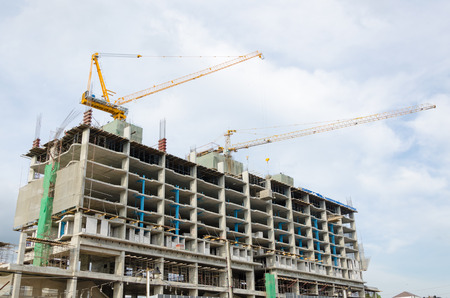 Outdoor buildings under construction with cranes 