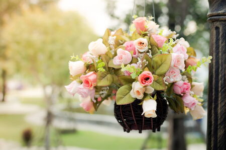 vintage style. Hanging basket of artificial flowers.の写真素材
