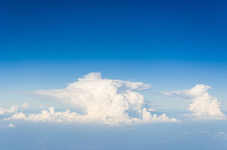 Blue sky and white clouds. view from the window of an airplane flying in the clouds.の写真素材