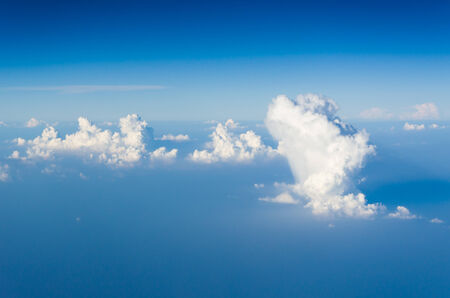 Blue sky and white clouds. view from the window of an airplane flying in the clouds.の写真素材