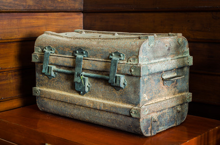 Ancient metal chest on wood table.の写真素材