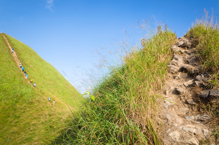 Mountaineer tourists hiking on (Khao Chang Puak) of mountains at Kanchanaburi, Thailand.の写真素材