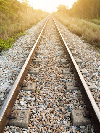 railway tracks in a rural scene with nice sunsetの写真素材