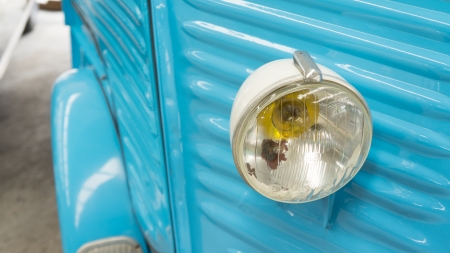 Blue classic car and headlightの写真素材