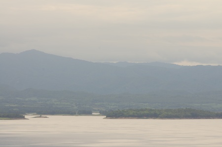 Mountain and water with fog in morningの写真素材