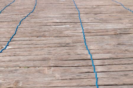 wood background and blue ropeの写真素材