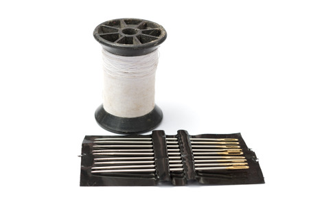 Pack of needle and white thread in white background