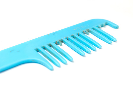 Be worn out blue comb on white backgroundの写真素材