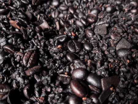 Close-up freshly roasted dark coffee beans, showcasing their rich texture and natural aroma. Perfect...
