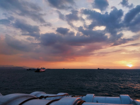 View of the horizon on the boat. Sunset. The background of the beauty of the sea and the sky that is starting to turn orange. The sun is setting, the sky displays a gradation of colors.の写真素材