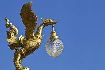 Golden swan comb hanger on top of lighting pole on blue sky background  This is the animal in Thai myth  The Thai name of this animal is Hong Tong or Hong の写真素材