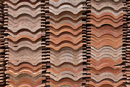 stack of red roof tiles, waving tilesの写真素材