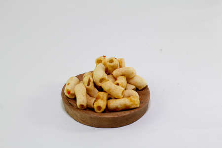 Spicy macaroni snacks, served on wooden containerの写真素材
