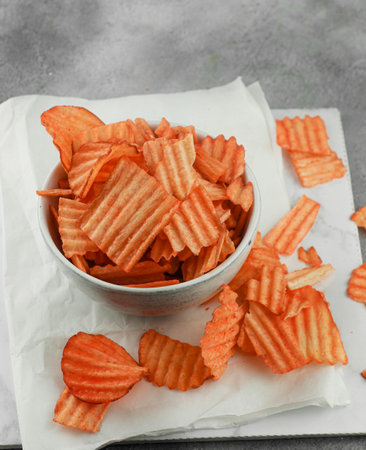 Cheese flavored cassava chips served in a bowl with a white theme