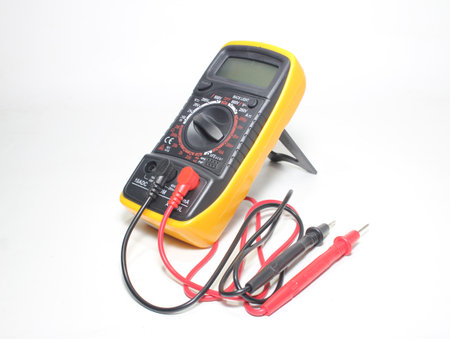 Digital multimeter with probes and display on a white background