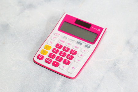 Pink calculator on white background for business financial conceptの写真素材