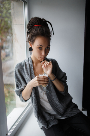 coffee girl earing red hair eyes windowの写真素材