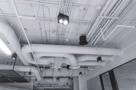 Large white water pipes inside the building. Clean modern sewage system in the building.の写真素材