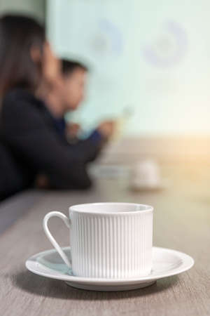 Close up of coffee cup on wooden conference table  in the meeting roomの写真素材