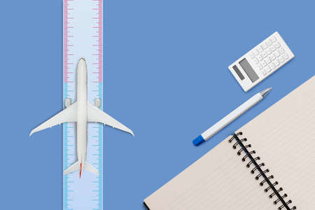 Aircraft model on ruler measure and diary book on blue color backgroundの写真素材
