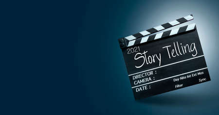 2021 story talking.Text title on film slate on black background.