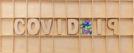 Concept design for children. COVID-19 wooden text and medicine
in wood box.の写真素材