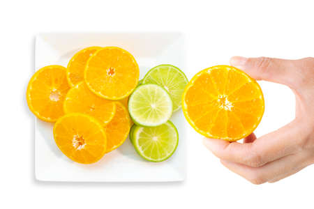 Women hands are choosing tangerines and lemons to make fruit juice.の写真素材