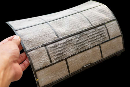 Dusty and dirty air conditioner filter on women hand  are a health hazard.の写真素材