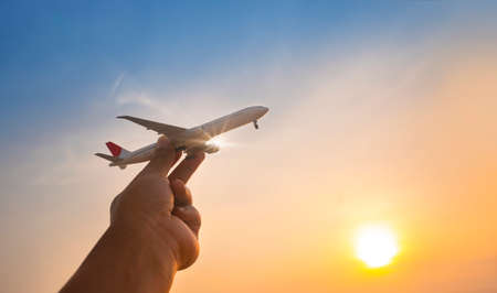 A model plane on a man's hand in the morningの写真素材