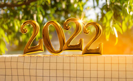 golden numbers 2022 Put it on the table in the garden in the morning. to prepare a party to start the new year in a warm houseの写真素材