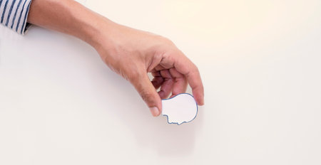 Hands holding the paper human head shape, brain stroke, world heart day, world health day, world mental health day, Alzheimer and wellness concept.の写真素材
