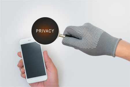 Magnifying glass of fraudsters. Data theft. and privacy in using the internet and smartphones .の写真素材