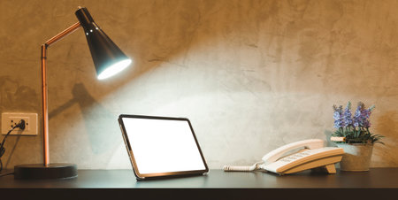 Empty tablet on desk at night For searching information, playing games or watching moviesの写真素材