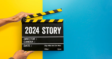 A new story begins in year 2024.Film industry worker holding film slate to tell a storyの写真素材