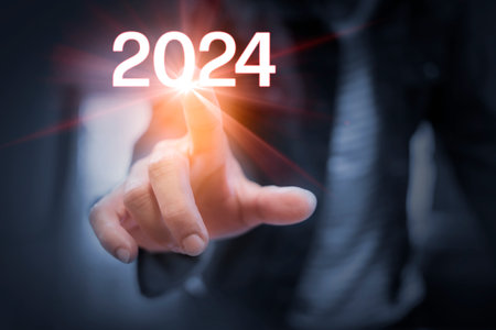 Business man's hands Touching the year 2024 and a light flashed out