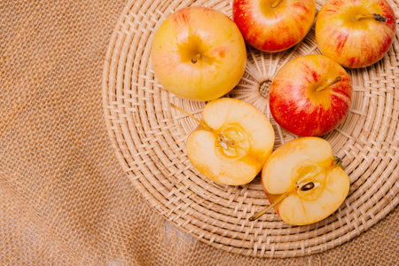 Groups of apples placed on a wooden tray for snacking or cooking. top view angle.