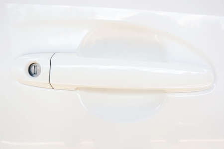 close up of White car door handle with lock holeの写真素材